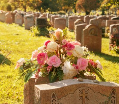 natural gold light on a floral arrangement on a headstone