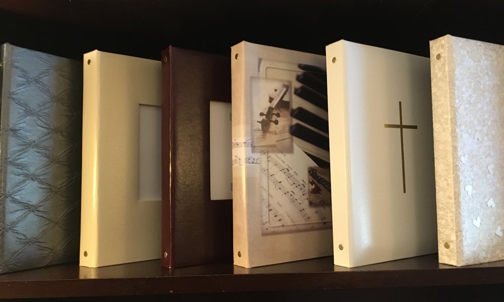 Registry books with fine paper, cross, piano keys, textured cover