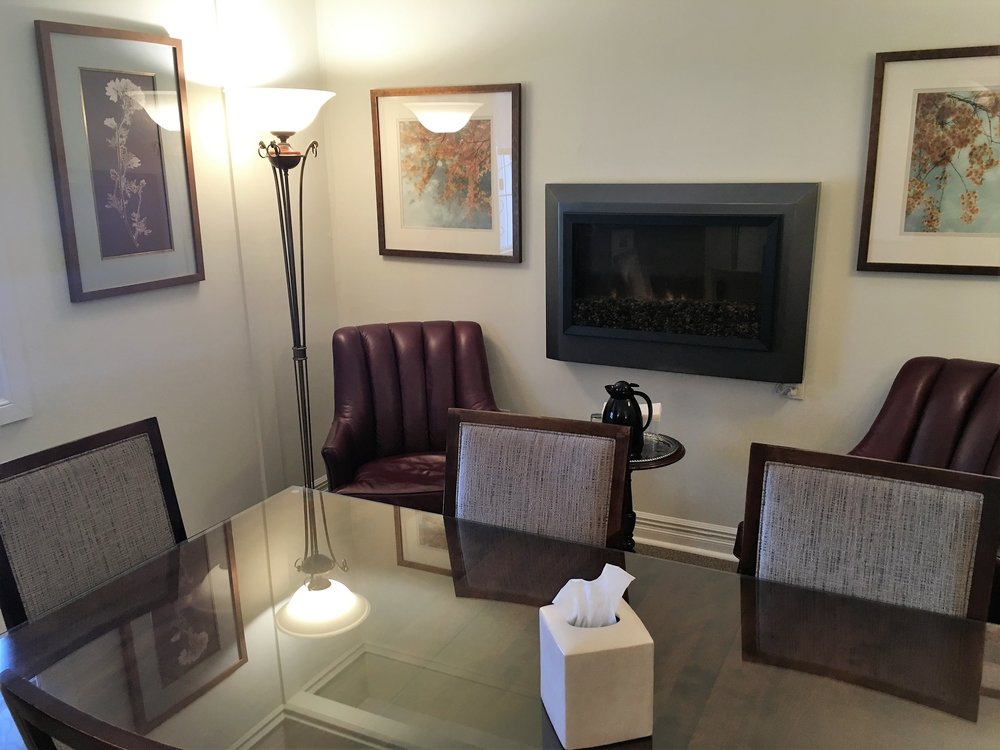 cozy lighting, comfortable chairs and fireplace in arrangement office