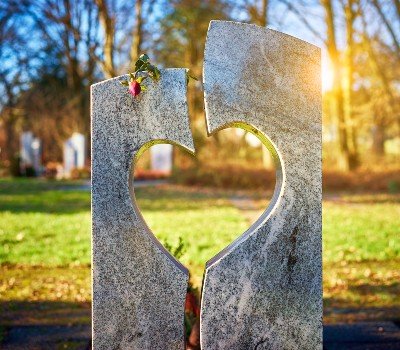 tombstone with a heart cut out of it at golden hour
